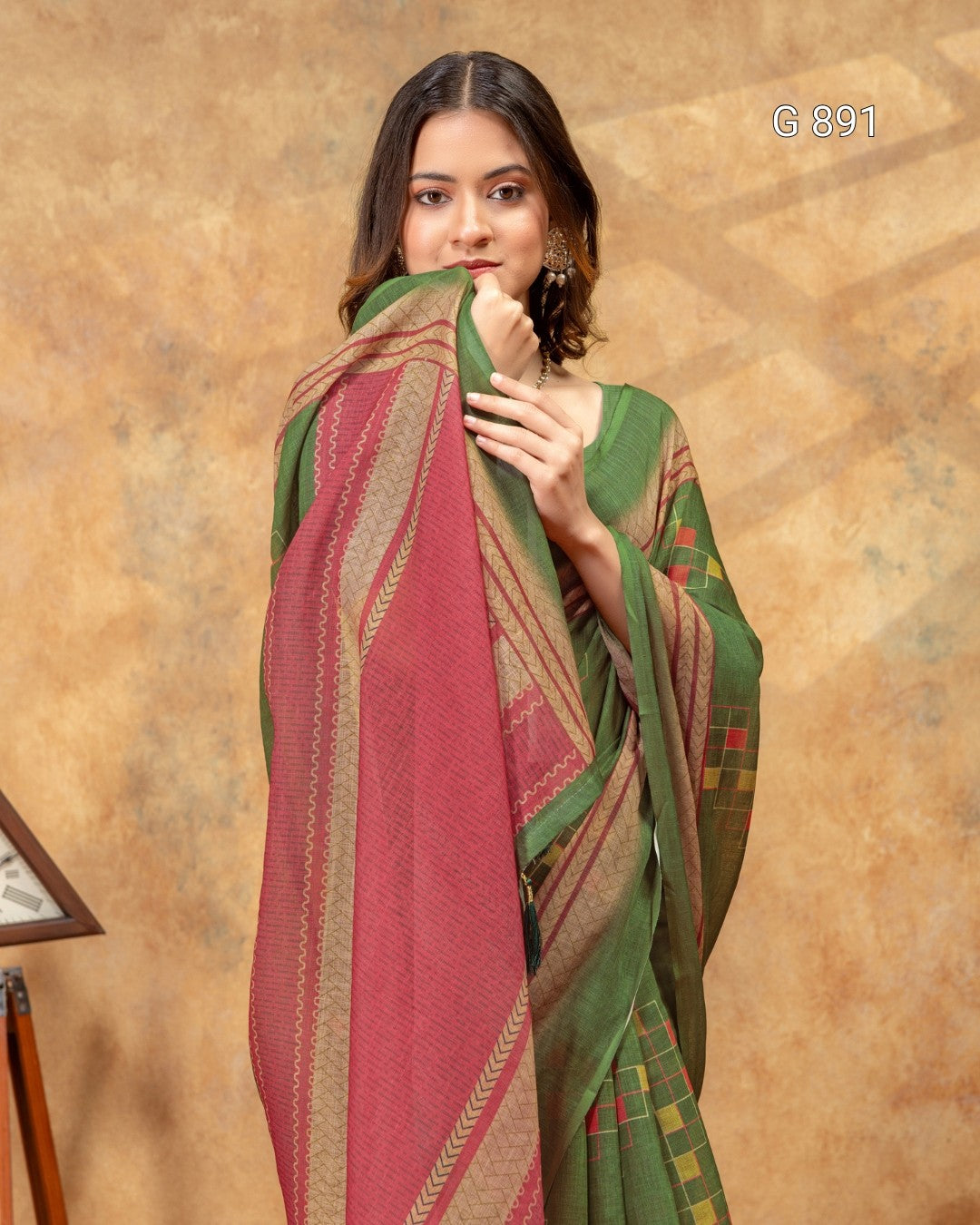 Woman wearing a green and red patterned scarf against a brown background