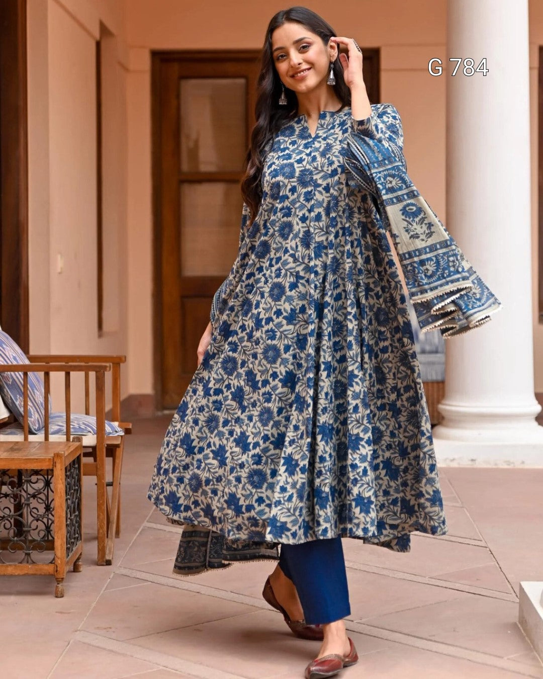 Woman wearing a blue floral dress in an outdoor setting
