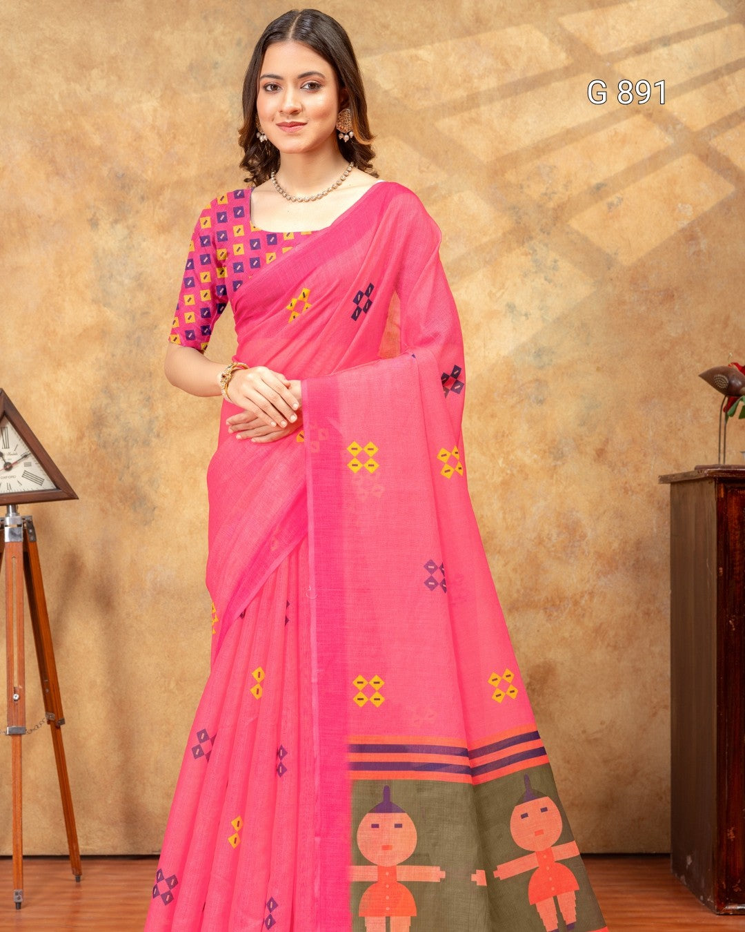 Woman wearing a pink saree with floral patterns against a beige background