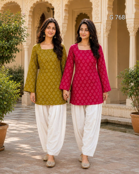 Two women in traditional outfits standing in front of a architectural background