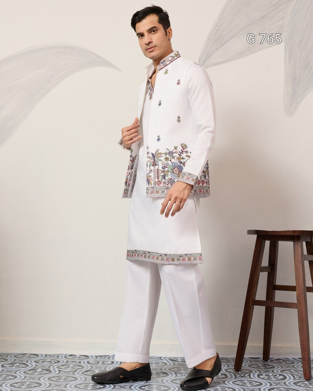 Man wearing a white embroidered kurta with pants in a minimalistic setting