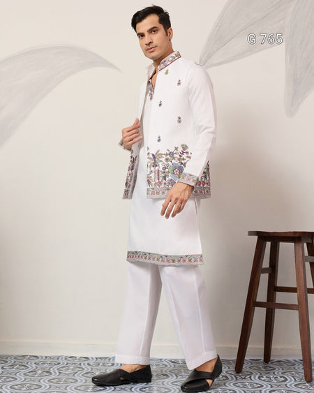 Man wearing a white embroidered kurta with pants in a minimalistic setting