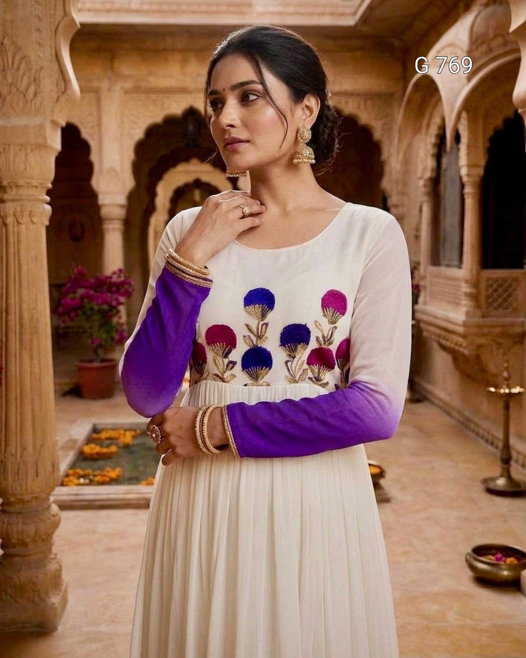 Woman wearing a traditional outfit with floral patterns in an ornate indoor setting