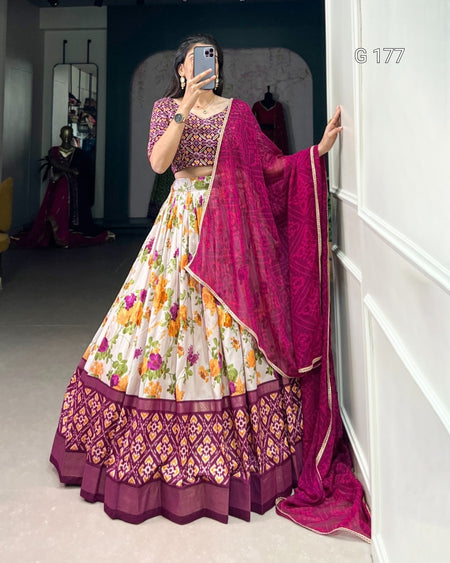 Woman in a floral lehenga with a pink dupatta taking a mirror selfie.