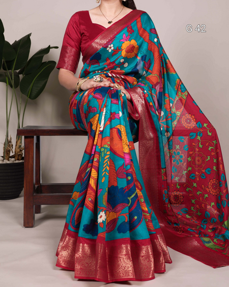Woman wearing a colorful saree with a floral pattern on a neutral background