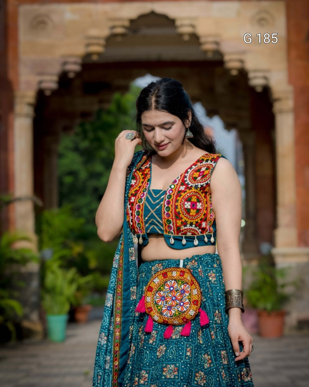 Woman in traditional outfit with colorful embroidery in an outdoor setting