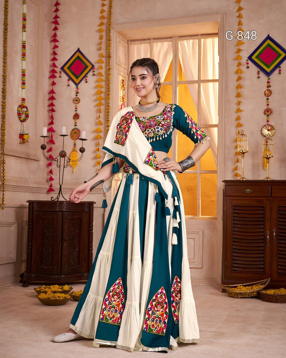 Woman in a traditional outfit with colorful patterns in a decorated room.