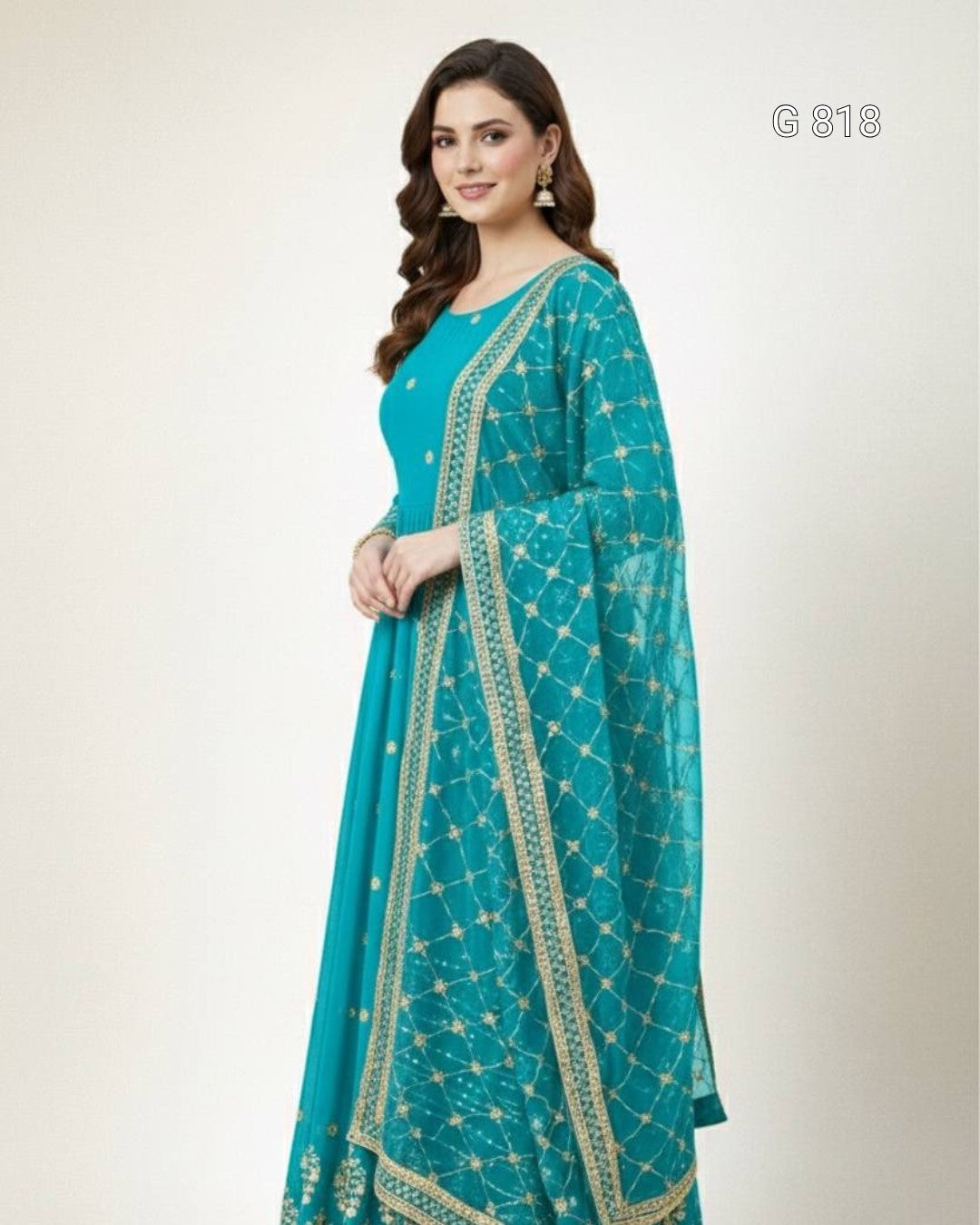 Woman wearing a teal traditional outfit with a matching dupatta on a white background