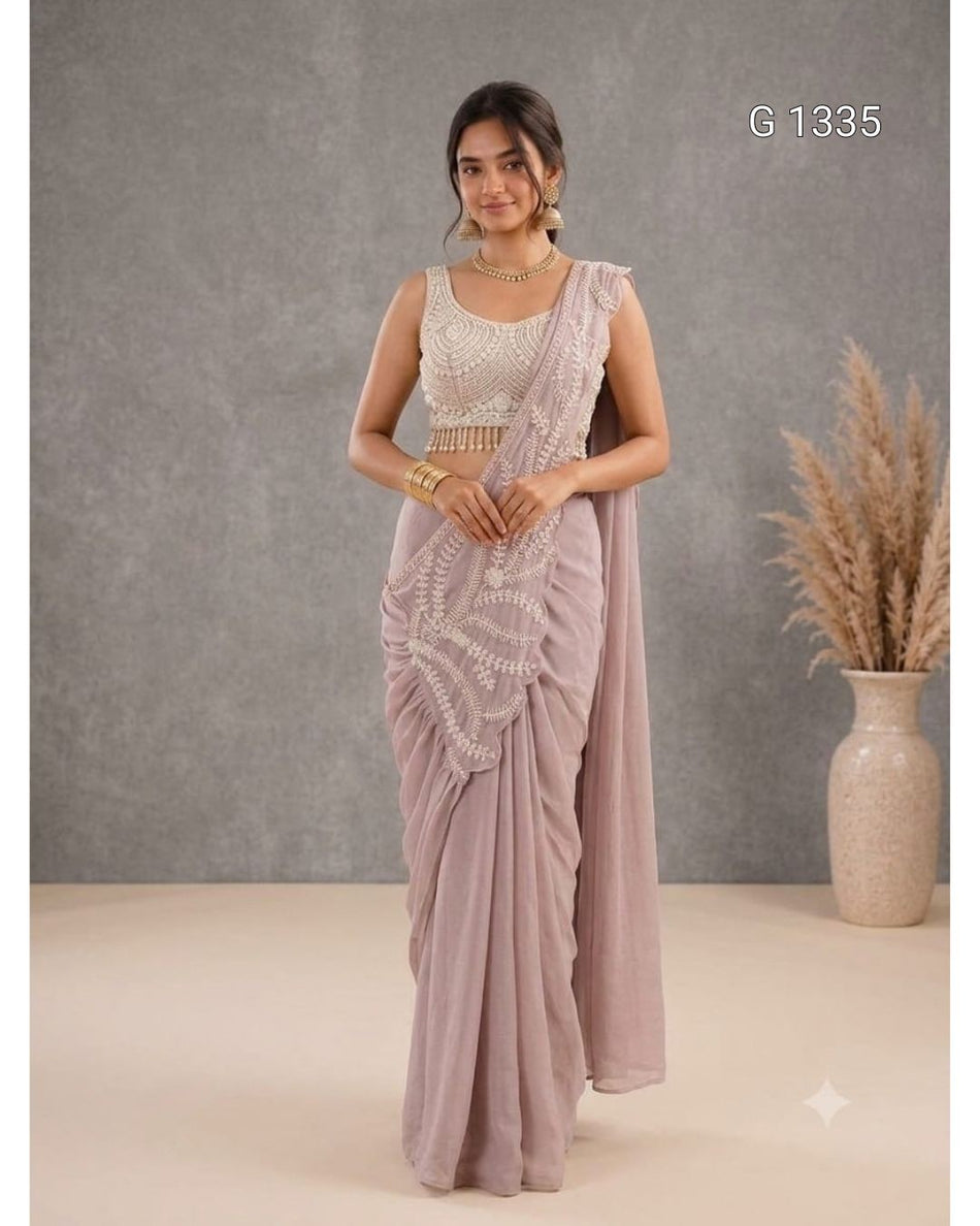 The graceful look is complemented with traditional jewelry, delicate tassels, and a beautifully draped pallu.