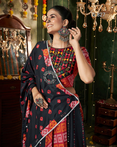 Woman in traditional attire with intricate jewelry in a decorated room.