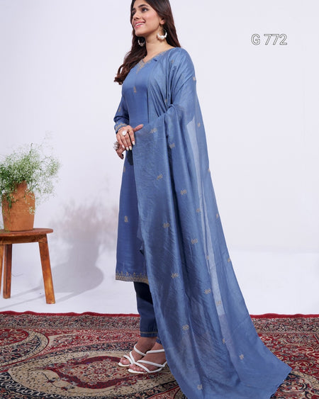 Woman wearing a blue traditional outfit with a white background