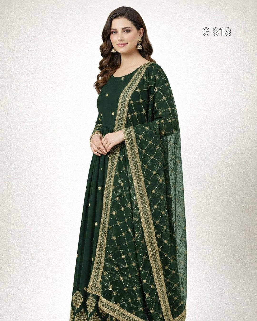 Woman wearing a green traditional outfit with gold embroidery on a white background