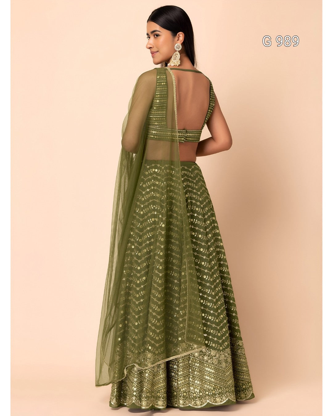 An olive green embroidered lehenga choli set with a sheer dupatta, shown on a model from the back against a solid beige background.