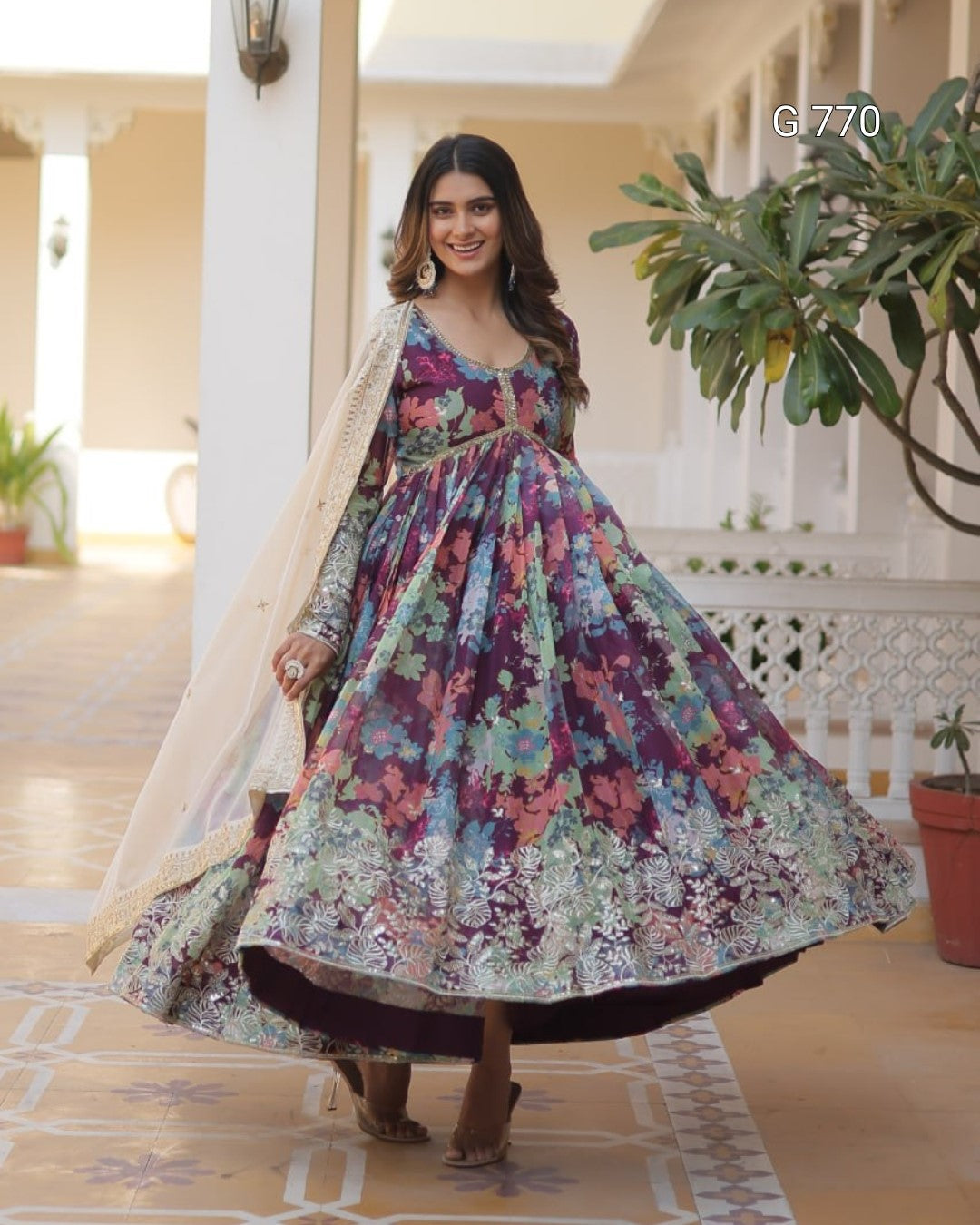 Woman wearing a colorful floral dress in an indoor setting