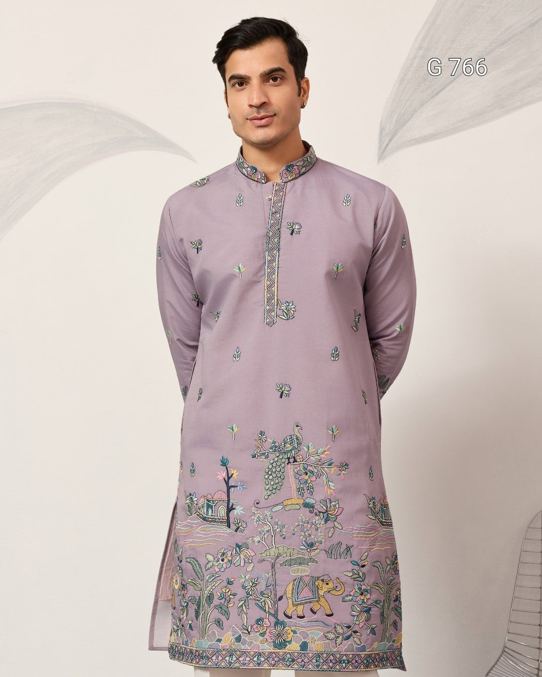 Man wearing a light purple embroidered kurta against a white background
