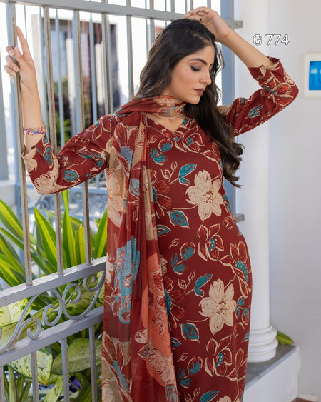 Woman wearing a floral patterned dress standing outdoors.