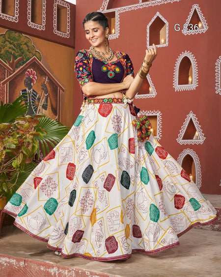 Woman in traditional outfit with colorful patterns against a decorative wall.