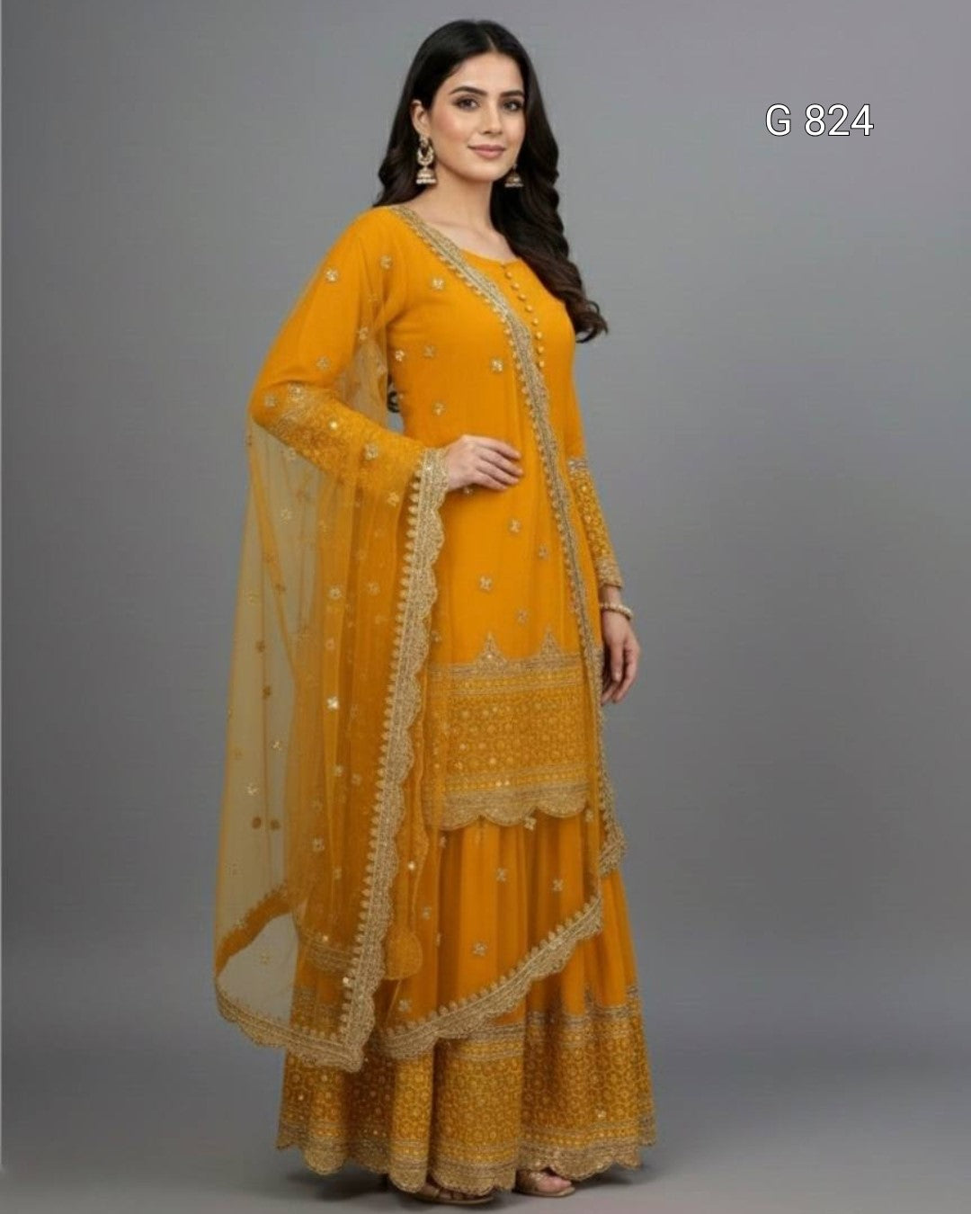 Woman wearing a mustard yellow traditional outfit with intricate designs on a gray background