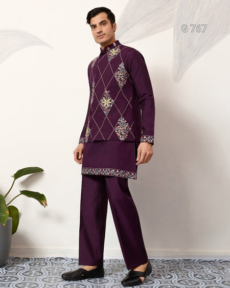 Man wearing a traditional embroidered outfit with a white background