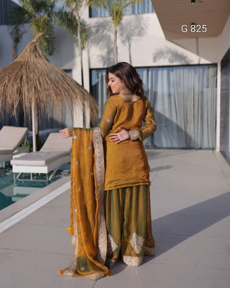 Woman in mustard yellow traditional outfit by a poolside
