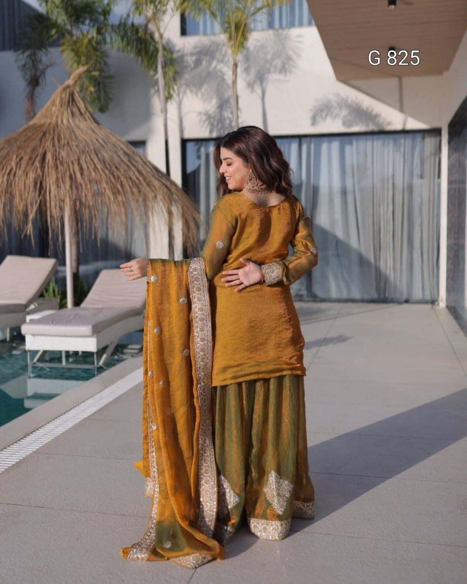 Woman in mustard yellow traditional outfit by a poolside