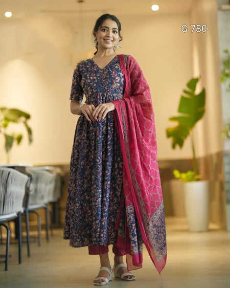 Woman wearing a blue and pink traditional outfit in an indoor setting