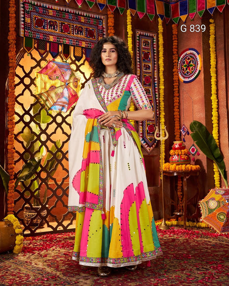 Woman in a colorful traditional outfit standing in front of a decorated background with 'G 839' text.