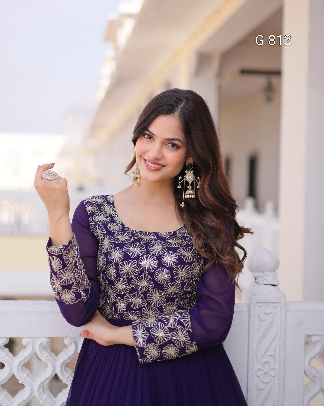 Woman wearing a purple dress with floral patterns in an outdoor setting