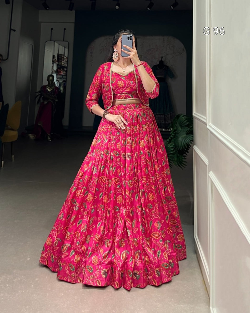 Person wearing a pink floral outfit taking a mirror selfie.