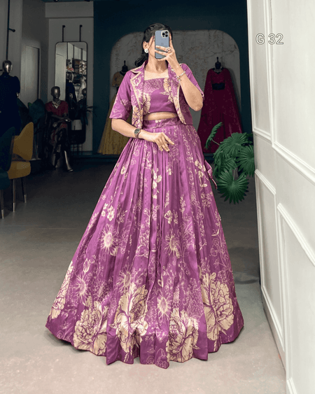 Person wearing a purple floral outfit in a room with a mirror and plant.