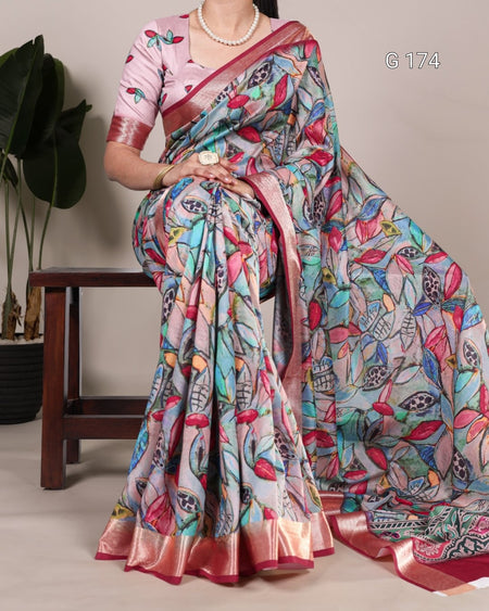 Colorful saree with intricate patterns draped over a person, with a neutral background.