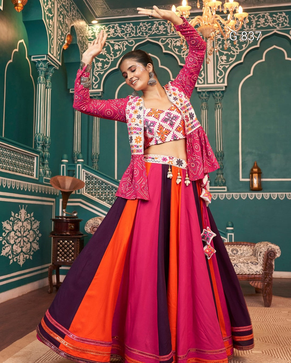 Woman in a colorful traditional outfit dancing in a decorated room.