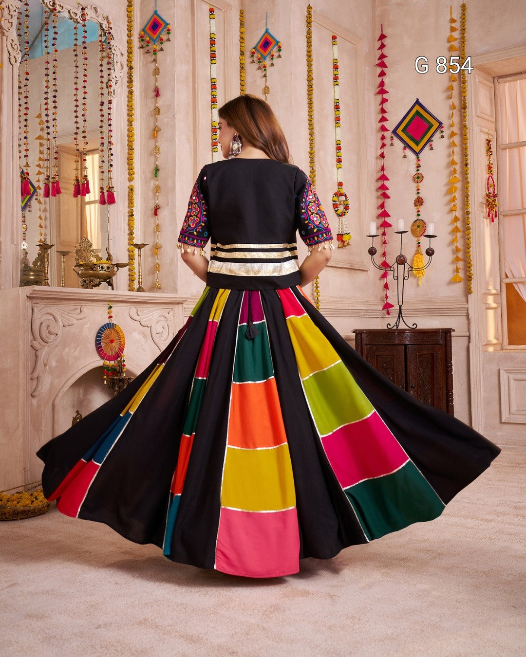 Woman in a colorful traditional outfit with a black background