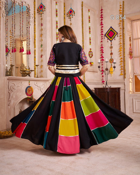 Woman in a colorful traditional outfit with a black background