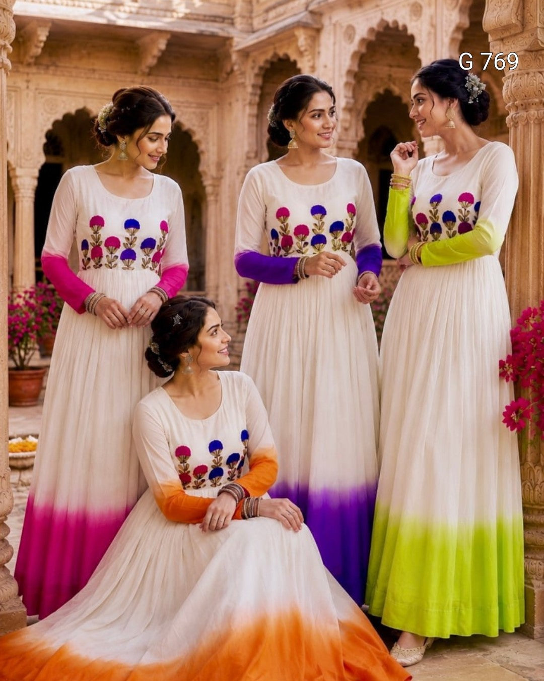 Four women in matching dresses with colorful floral patterns in an ornate indoor setting.