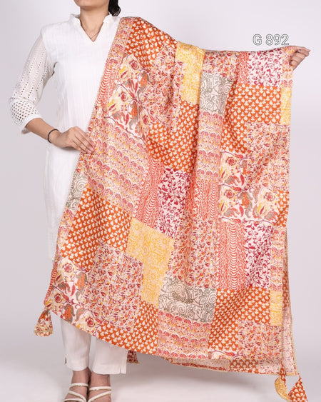 Person holding a colorful patterned scarf with a white background
