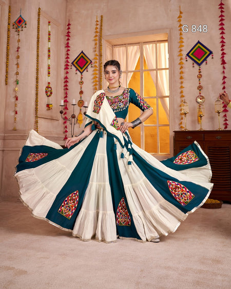 Woman in a traditional embroidered saree with a decorative background