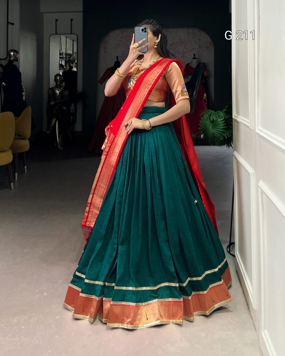 Person wearing a green and red traditional outfit in a room setting.