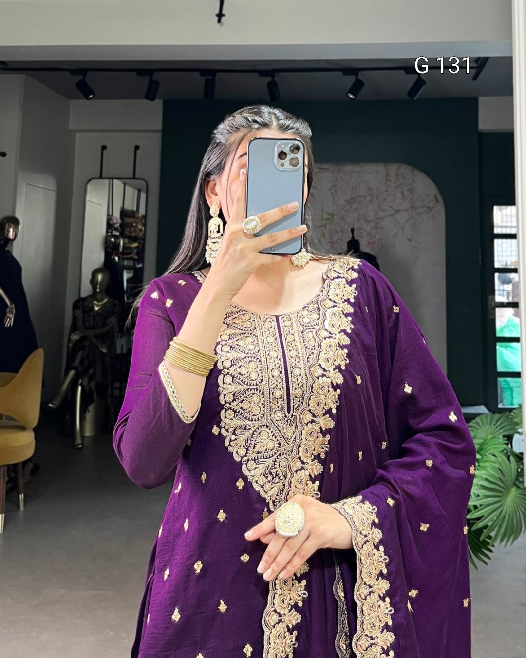 Person wearing a purple embroidered outfit taking a mirror selfie.
