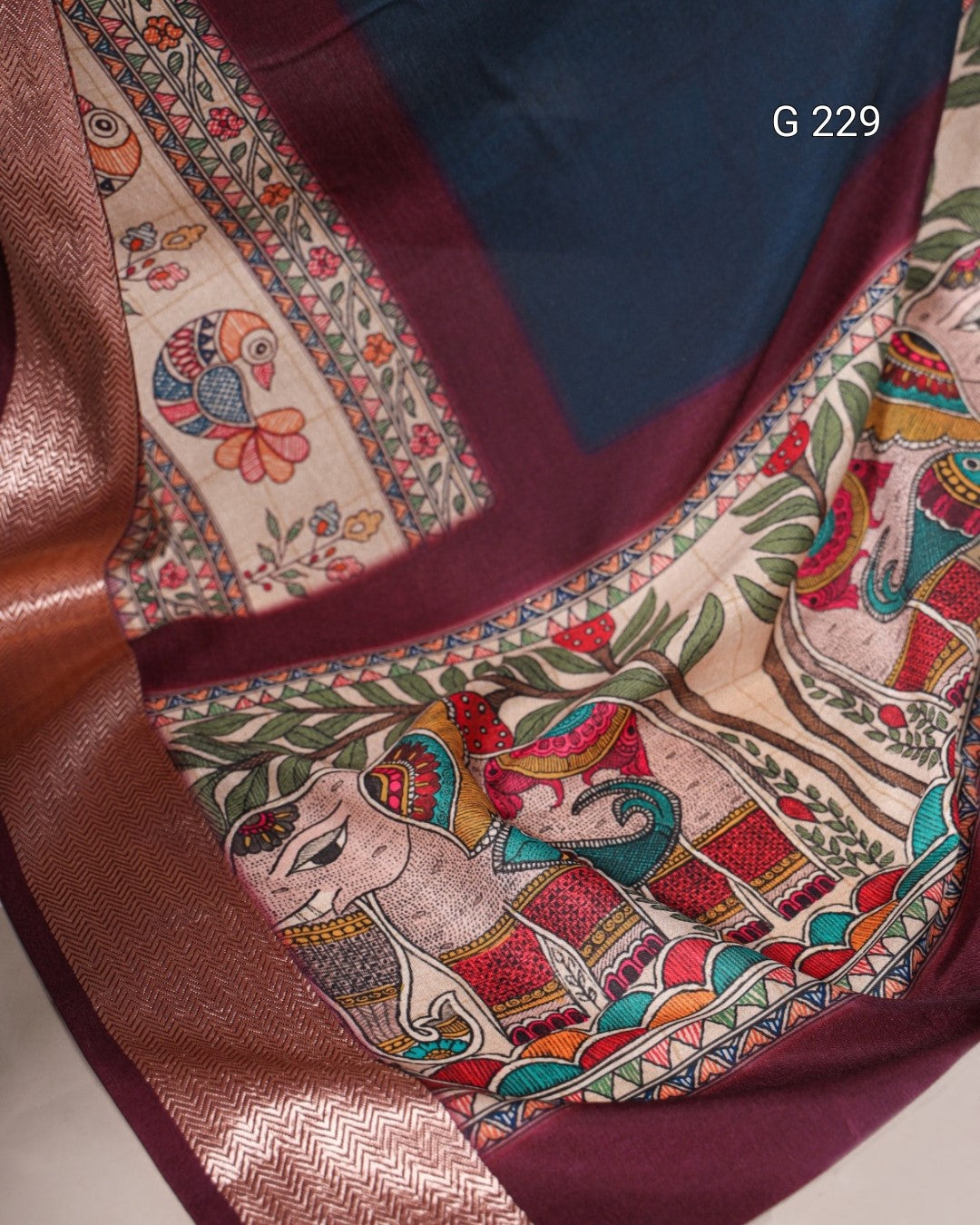 Colorful fabric with intricate patterns and designs, featuring a figure and floral elements.