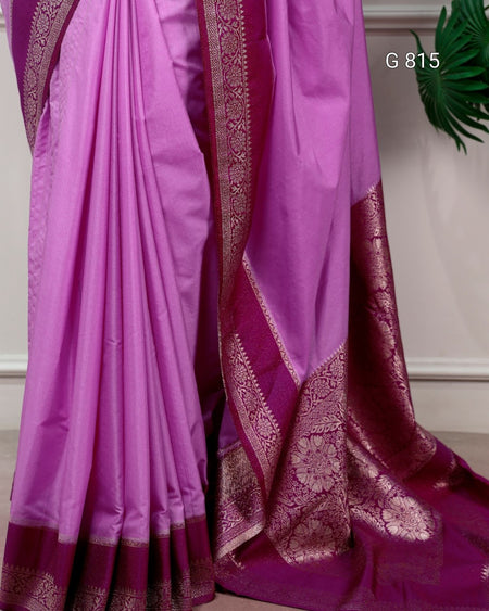 Purple saree with gold border on a neutral background