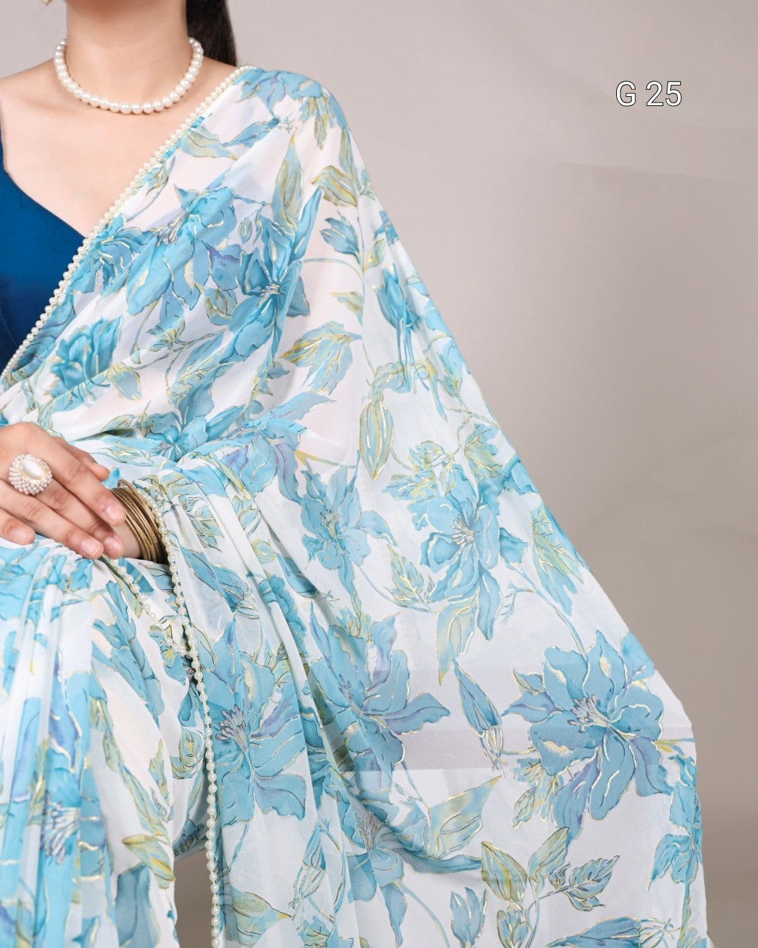 Light blue floral saree with a plain background
