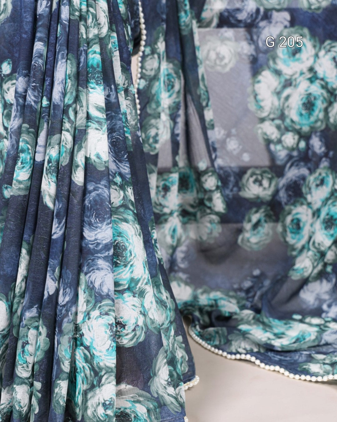 Close-up of a floral patterned fabric with blue and green colors.
