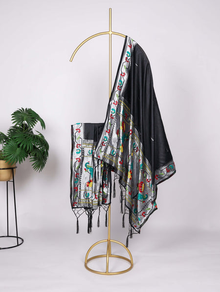 Decorative scarf with colorful patterns draped over a gold stand against a white background