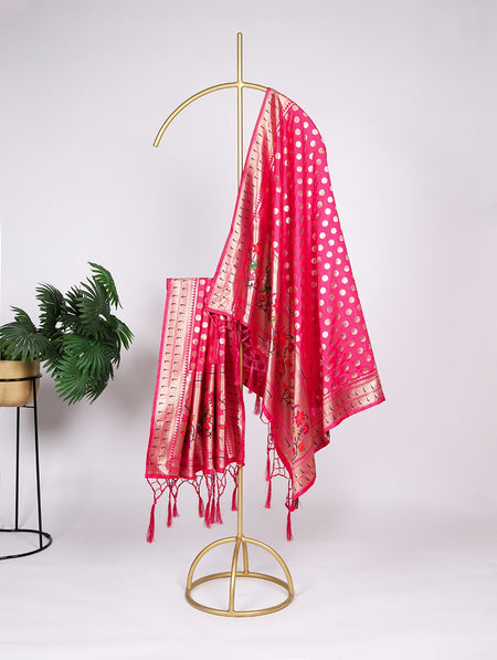 Red patterned scarf draped over a gold stand with a white background