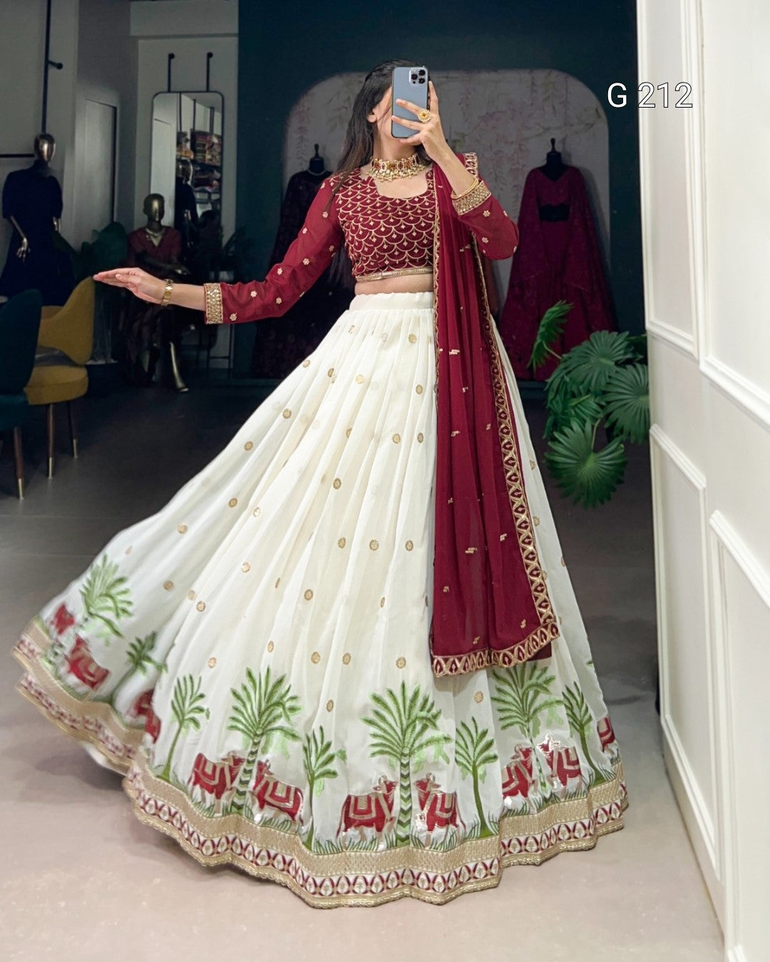 Person wearing a traditional outfit with a red blouse and white skirt with floral patterns, standing in a room.