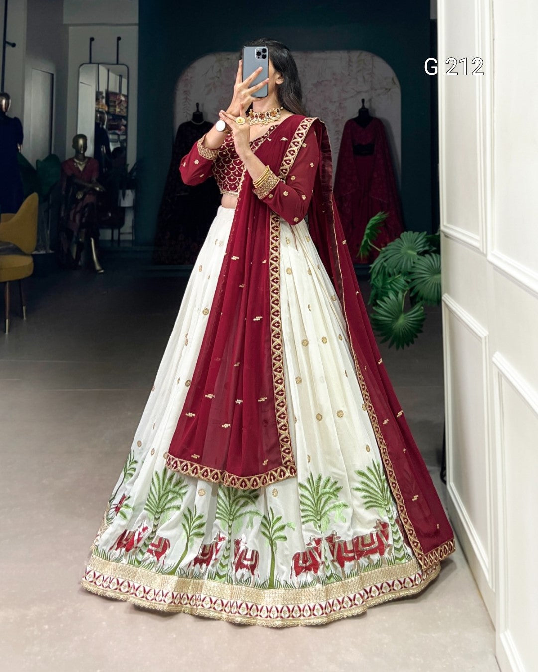 Woman wearing a red and white embroidered traditional outfit in a room.