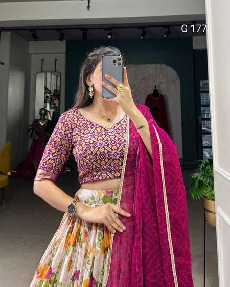 Person wearing a traditional outfit with a purple blouse and floral skirt in a store setting.