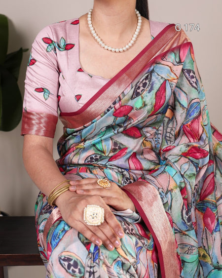 Person wearing a colorful saree with a pink blouse, holding hands together.