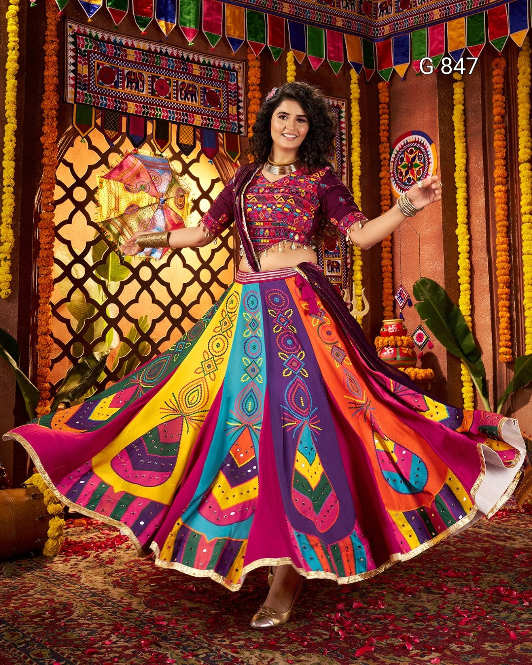 Woman in a colorful traditional outfit dancing in a decorated room.